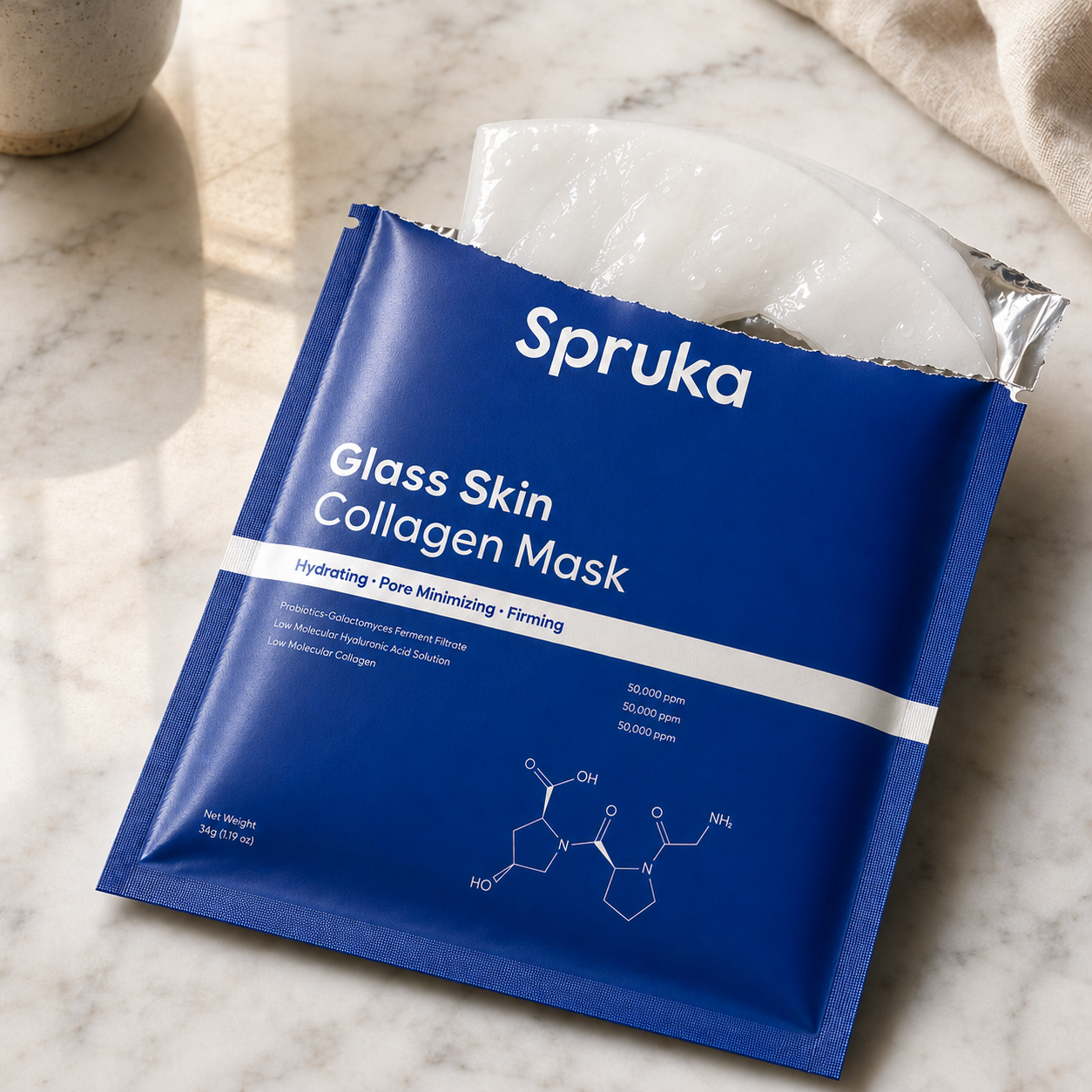 Spruka foil pouch resting on a marble countertop, hydrogel mask peeking out
